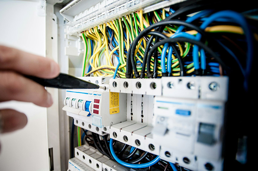 A Minneapolis electrician repairing an electrical control panel