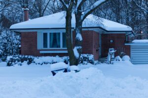 A snow-covered house and yard