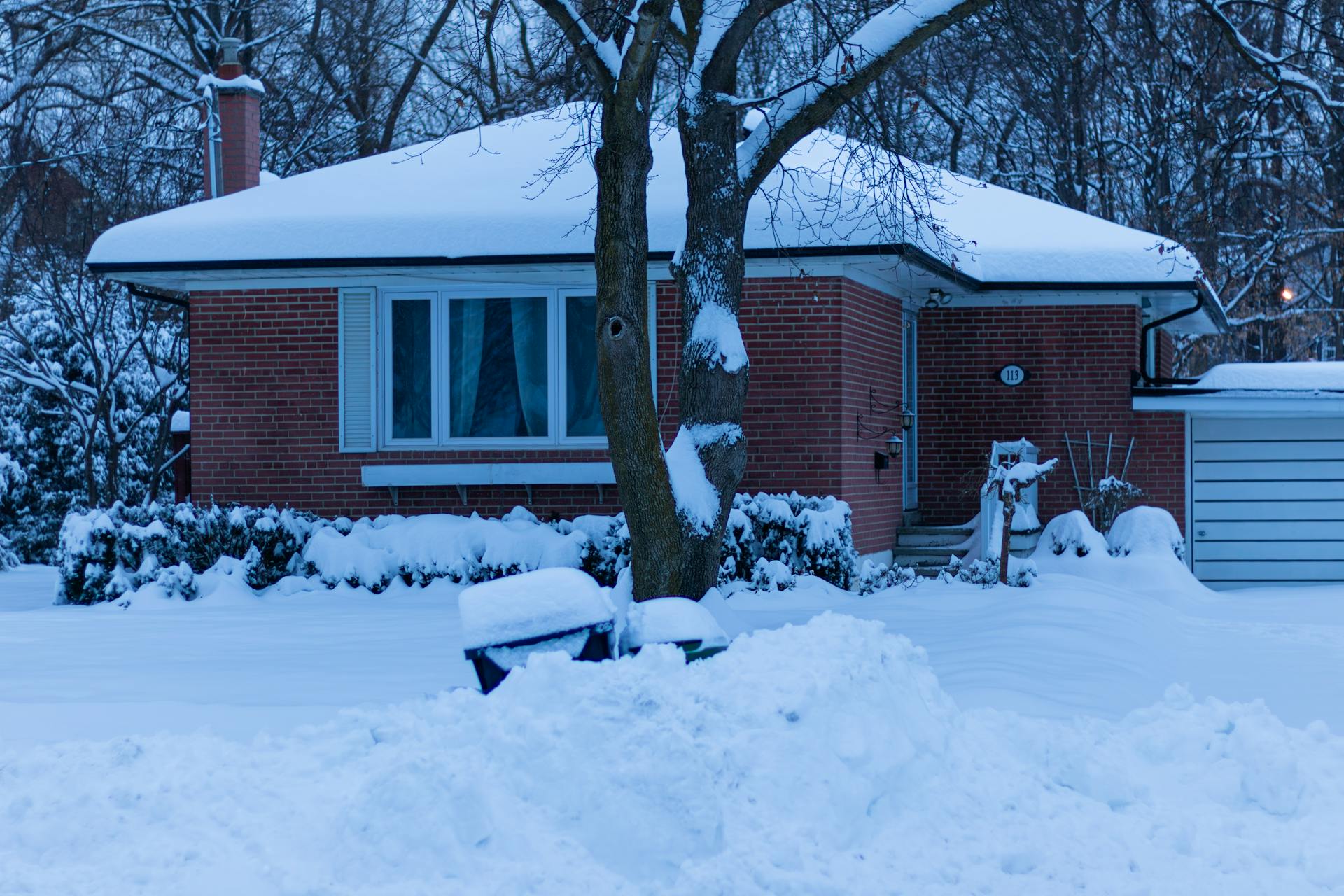 A snow-covered house and yard